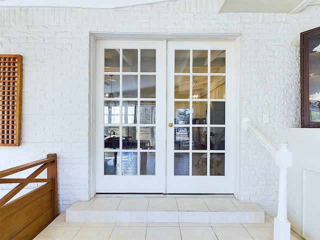 doorway to outside featuring tile patterned floors and french doors