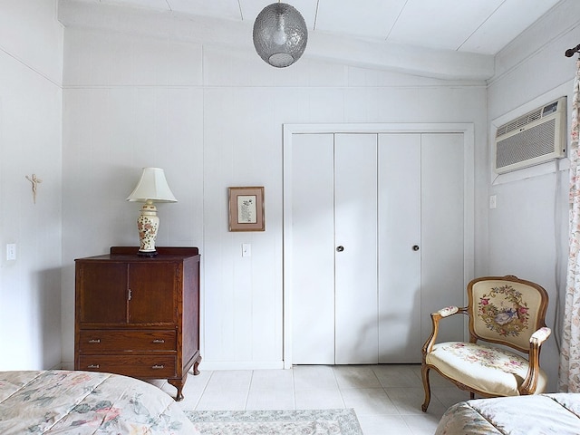 tiled bedroom with a closet and an AC wall unit