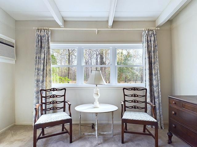 sitting room with light colored carpet and beam ceiling