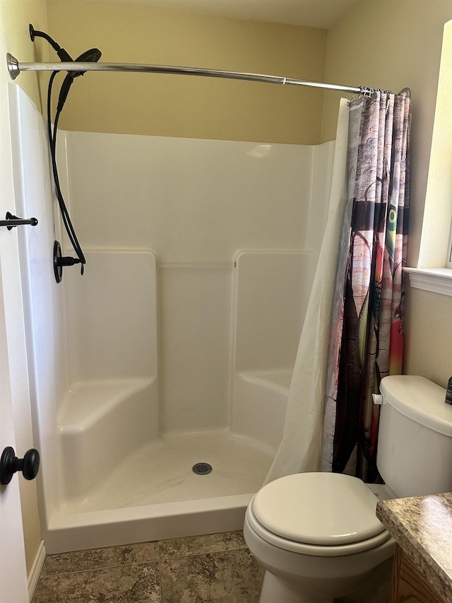 bathroom with vanity, curtained shower, and toilet