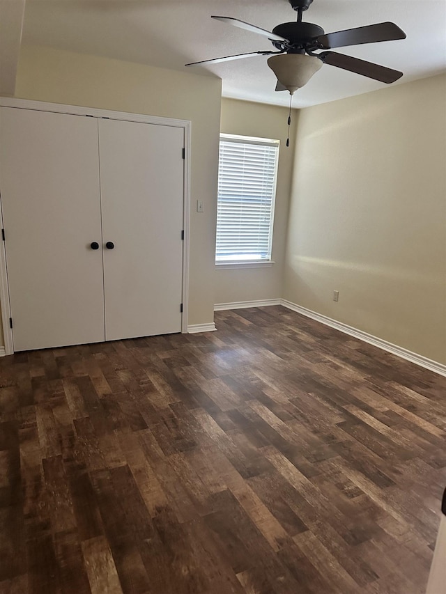 unfurnished bedroom featuring ceiling fan, a closet, and dark hardwood / wood-style floors