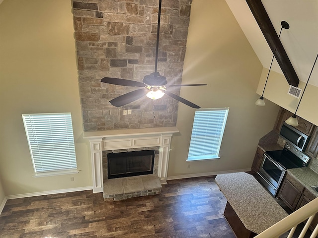 unfurnished living room with beamed ceiling, dark hardwood / wood-style floors, and high vaulted ceiling