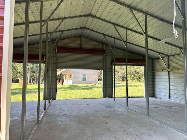 view of parking / parking lot with a yard and a carport