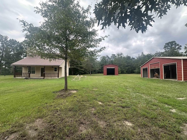 view of yard with covered porch and a storage unit