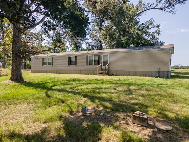 rear view of house with a lawn