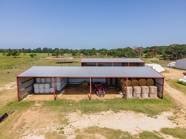 view of horse barn featuring a rural view