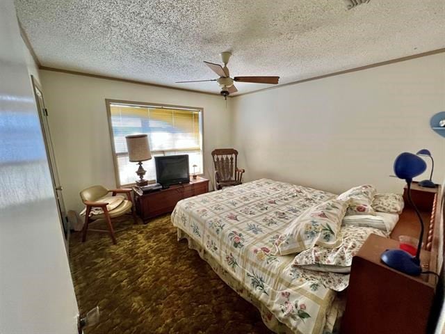 bedroom featuring ceiling fan, ornamental molding, and a textured ceiling