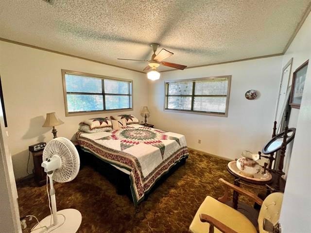 carpeted bedroom with ceiling fan and a textured ceiling