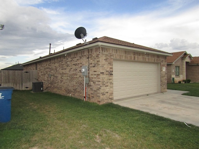 view of side of home with cooling unit, a garage, and a yard