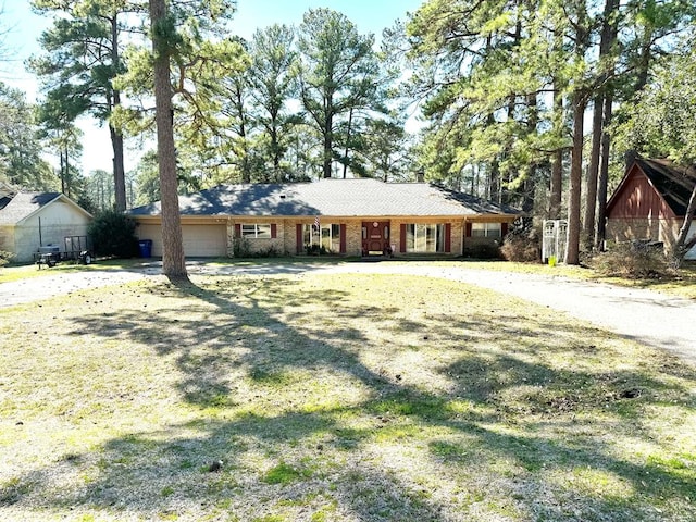 single story home with a garage and a front yard