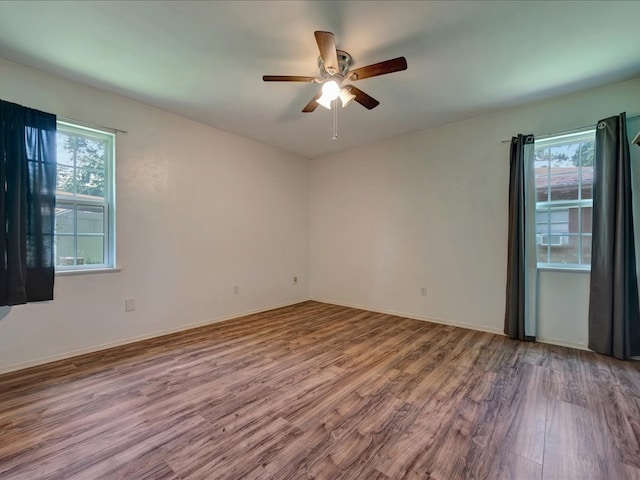 1313 Glass Ave, Diboll, TX 75941 - unfurnished room featuring wood finished floors, healthy amount of natural light, and a ceiling fan