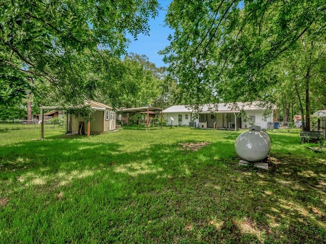 1313 Glass Ave, Diboll, TX 75941 - view of yard with a shed and a detached carport
