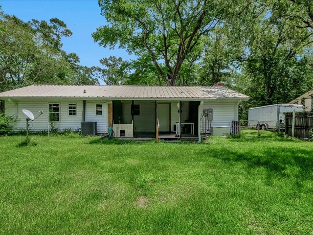 1313 Glass Ave, Diboll, TX 75941 - rear view of house featuring a metal roof and a chimney