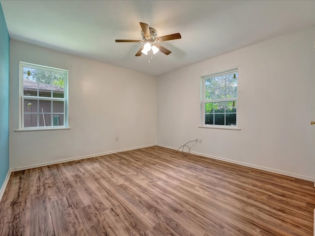 1313 Glass Ave, Diboll, TX 75941 - spare room with healthy amount of natural light, wood finished floors, and a ceiling fan