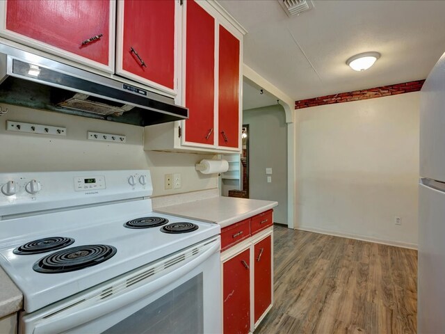 1313 Glass Ave, Diboll, TX 75941 - kitchen featuring white appliances, red cabinetry, exhaust hood, and light wood-style flooring