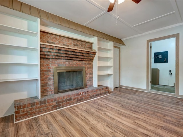 1313 Glass Ave, Diboll, TX 75941 - unfurnished living room featuring wood finished floors, a brick fireplace, and ceiling fan