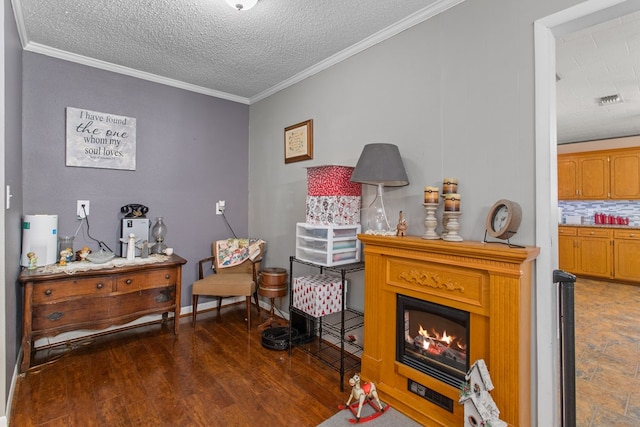 living area featuring a textured ceiling, dark hardwood / wood-style flooring, and ornamental molding