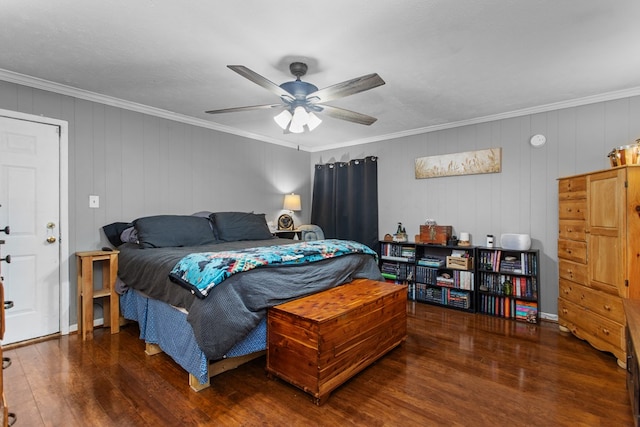 bedroom with ceiling fan, wood walls, dark hardwood / wood-style flooring, and crown molding