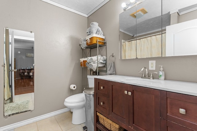 bathroom with vanity, tile patterned flooring, toilet, ornamental molding, and a textured ceiling