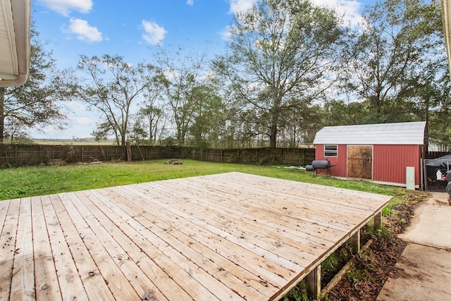 deck with a yard and a shed