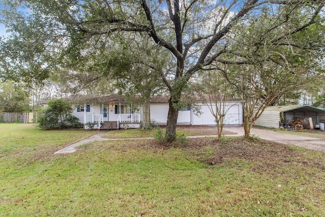 view of front of house featuring a carport, covered porch, and a front yard