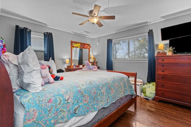 bedroom with crown molding, ceiling fan, and dark wood-type flooring