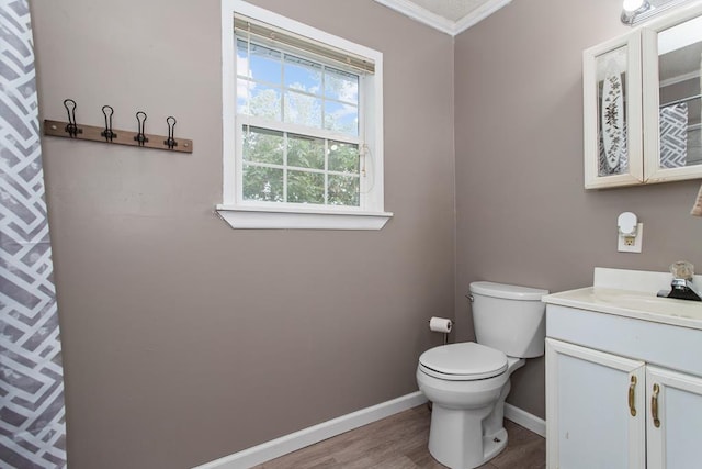 bathroom featuring hardwood / wood-style floors, vanity, toilet, and ornamental molding