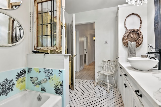 bathroom featuring vanity and a tub