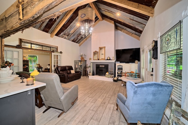 living room featuring beamed ceiling, high vaulted ceiling, a chandelier, and light hardwood / wood-style floors