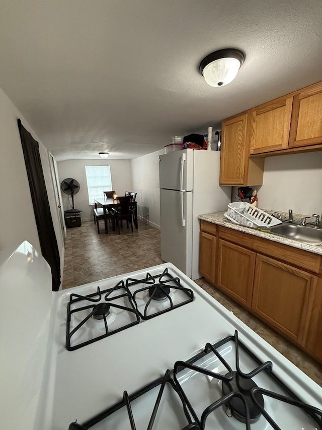 kitchen with a textured ceiling and white appliances