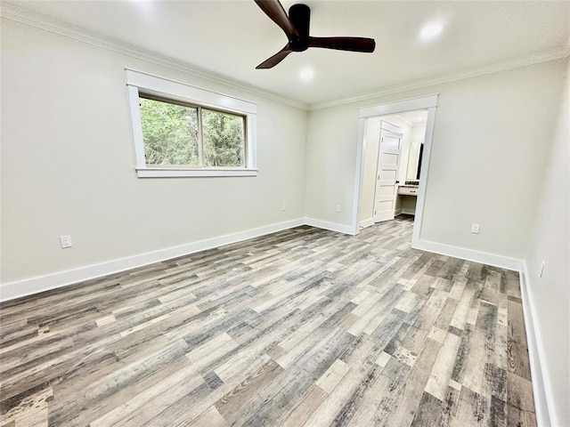 empty room with crown molding, ceiling fan, and light wood-type flooring