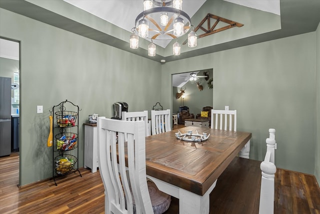 dining room with dark wood-type flooring and a notable chandelier