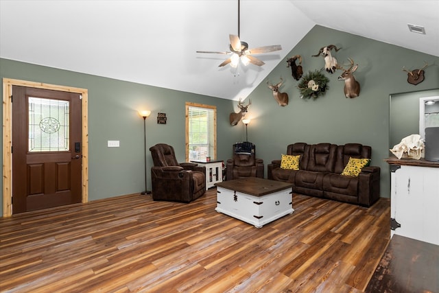 living room featuring ceiling fan, lofted ceiling, and dark wood-type flooring