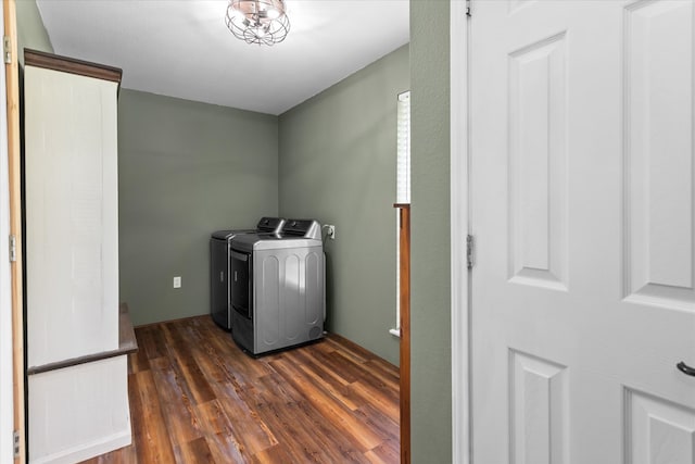 clothes washing area featuring dark hardwood / wood-style flooring and washing machine and dryer