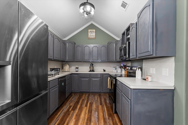 kitchen with gray cabinetry, stainless steel appliances, dark hardwood / wood-style floors, crown molding, and lofted ceiling