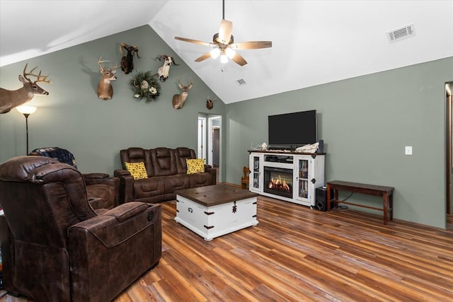 living room with hardwood / wood-style floors, ceiling fan, and lofted ceiling