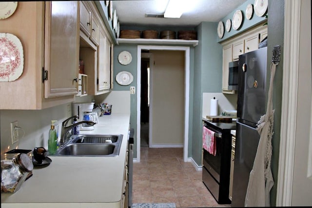 1003 Linton Lanier Ln, Jasper, TX 75951 - kitchen with stainless steel appliances, a sink, light countertops, and baseboards