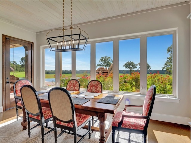 dining space featuring baseboards, an inviting chandelier, and wooden ceiling