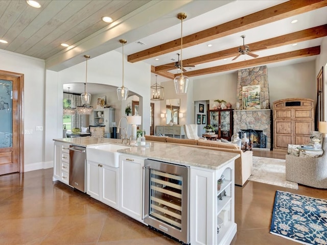 1811 Caspers Cv, Lufkin, TX 75904 - kitchen with beverage cooler, open floor plan, white cabinets, recessed lighting, and light stone countertops