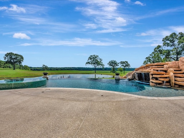 view of swimming pool with a water view