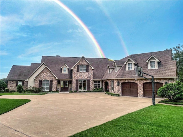 view of front of home with driveway, a front lawn, and a shingled roof