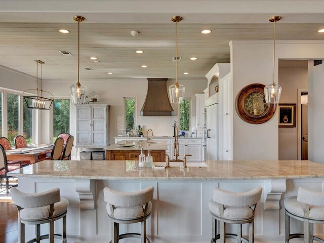 living room featuring a towering ceiling, beamed ceiling, and ceiling fan with notable chandelier