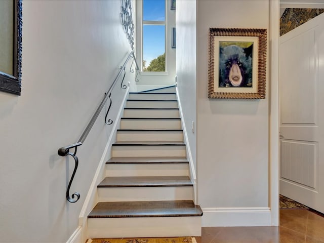 stairs featuring tile patterned floors