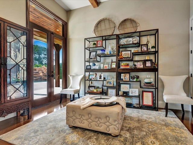 living area with french doors and beamed ceiling