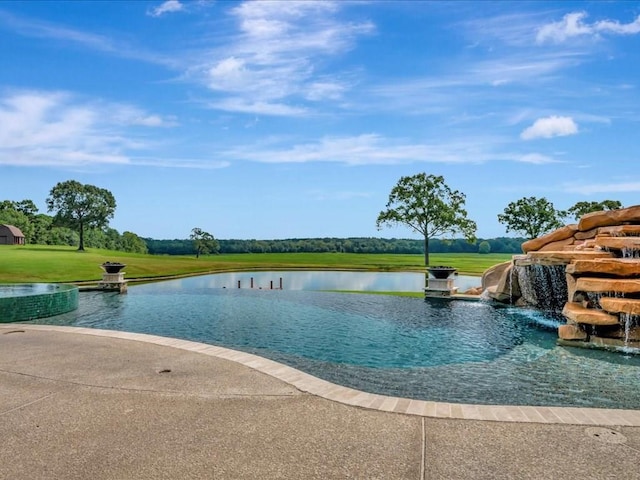 view of swimming pool with a lawn, a water view, and an infinity pool