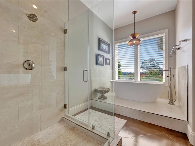 bathroom with tile patterned flooring and shower with separate bathtub