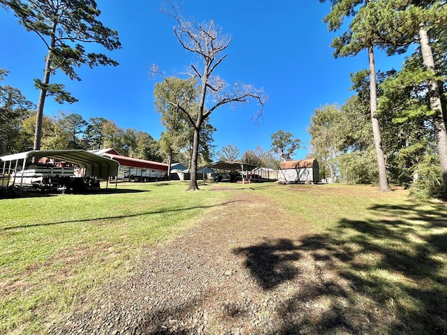 670 Cedar Crest Cir, Hemphill, TX 75948 - view of green lawn featuring a detached carport