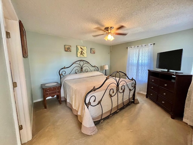 670 Cedar Crest Cir, Hemphill, TX 75948 - bedroom with light colored carpet, a textured ceiling, a ceiling fan, and baseboards