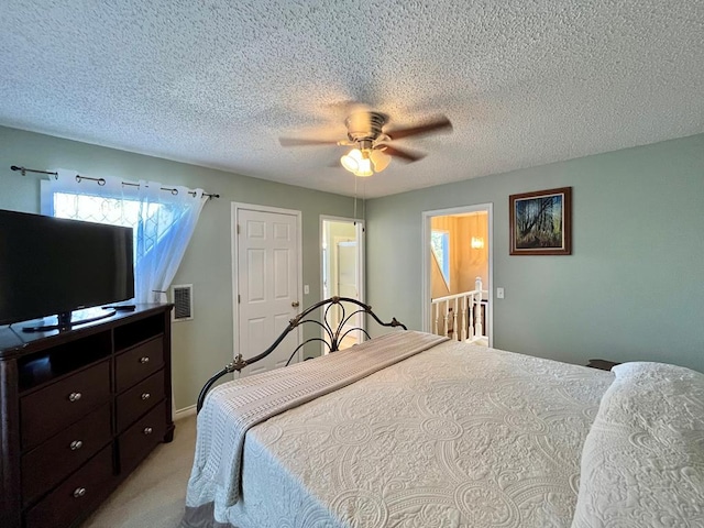 670 Cedar Crest Cir, Hemphill, TX 75948 - carpeted bedroom featuring a textured ceiling and a ceiling fan