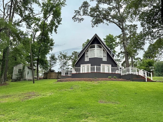 670 Cedar Crest Cir, Hemphill, TX 75948 - back of house featuring a wooden deck, a yard, and an outbuilding